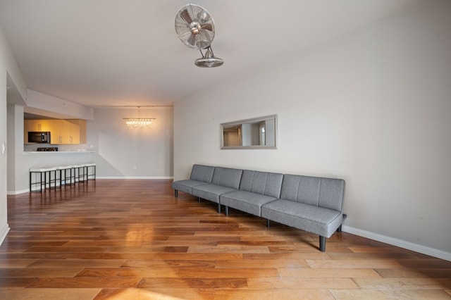 living room featuring hardwood / wood-style flooring and a notable chandelier