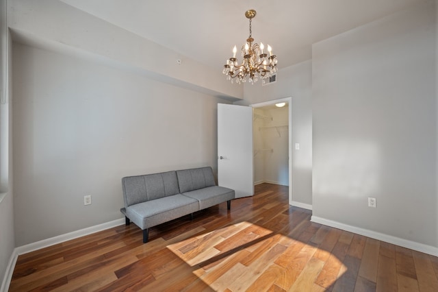 living area with dark hardwood / wood-style flooring and a notable chandelier