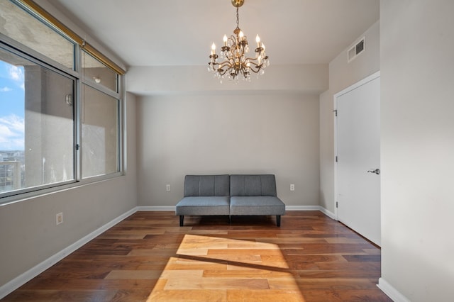 unfurnished room with dark hardwood / wood-style flooring and an inviting chandelier