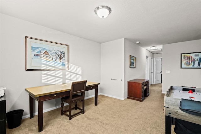 office area featuring light carpet and baseboards