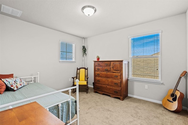 bedroom featuring light colored carpet