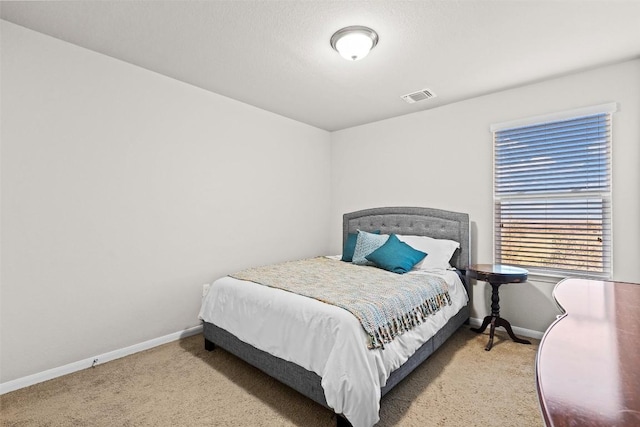 bedroom with light colored carpet