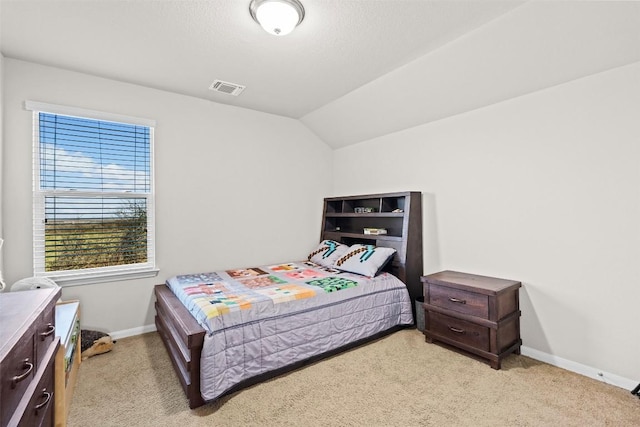 bedroom with light carpet, baseboards, and lofted ceiling
