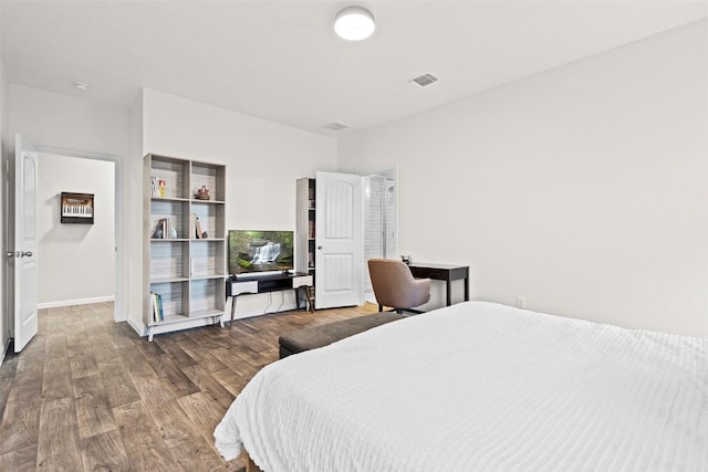bedroom featuring wood finished floors and baseboards