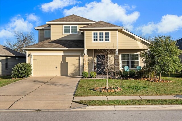 view of front of property with a front yard and a garage