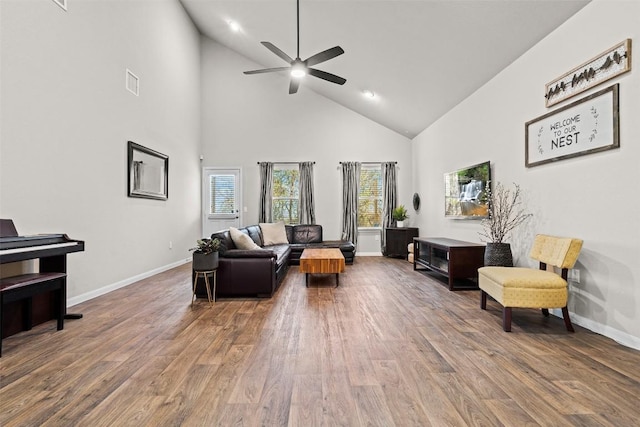 living room featuring wood-type flooring, high vaulted ceiling, and ceiling fan