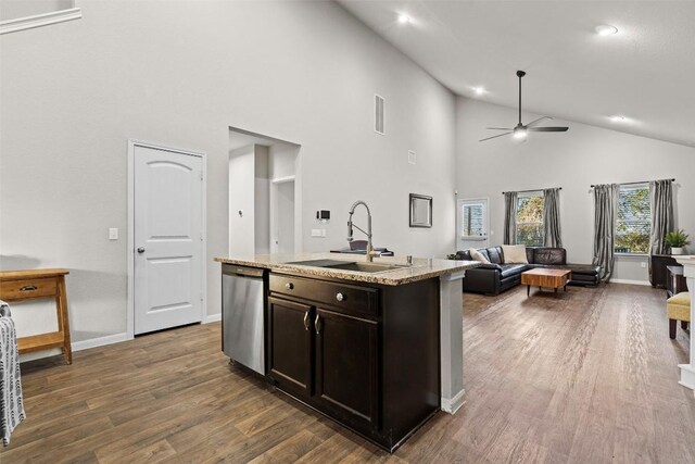 kitchen featuring dishwasher, sink, ceiling fan, dark brown cabinetry, and a center island with sink