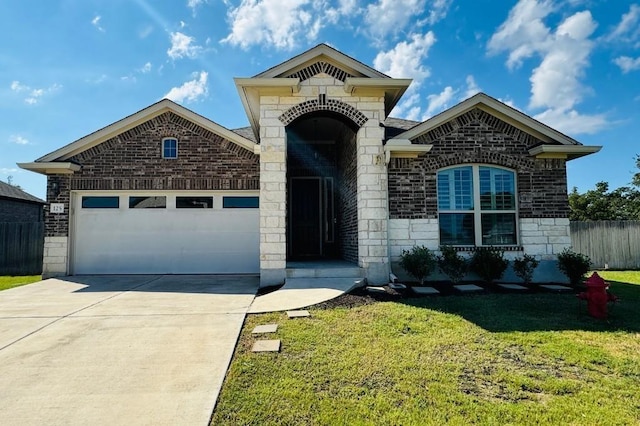 view of front of house with a front yard and a garage