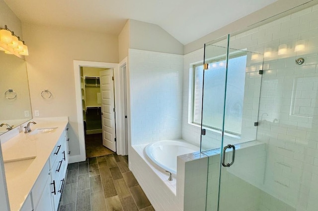 bathroom with vanity and shower with separate bathtub