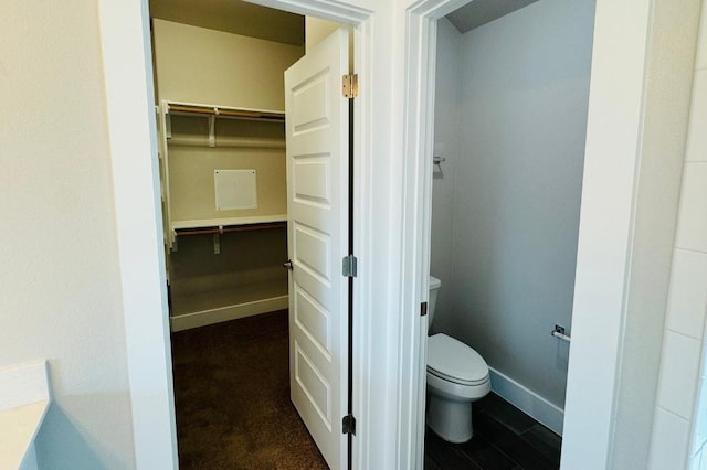 125 Millsaps Ct, Bastrop, TX 78602 - bathroom featuring toilet, a spacious closet, and baseboards