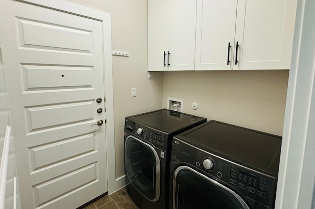 laundry area with cabinets, washer and dryer, and dark hardwood / wood-style floors