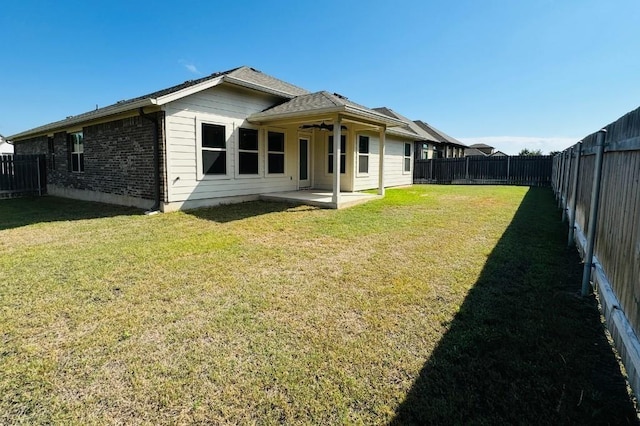 125 Millsaps Ct, Bastrop, TX 78602 - back of property with a ceiling fan, a patio, and brick siding