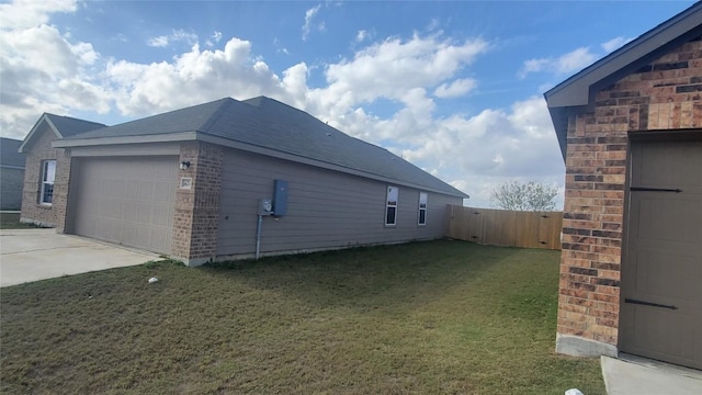 view of property exterior featuring a yard and a garage