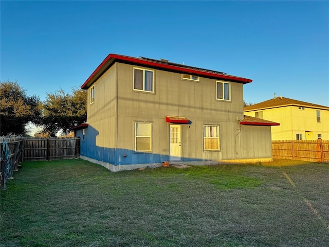 back of property featuring a lawn