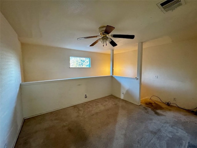 spare room with ceiling fan and carpet