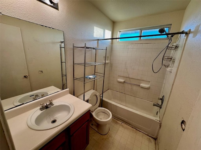 full bathroom with tiled shower / bath combo, toilet, and vanity