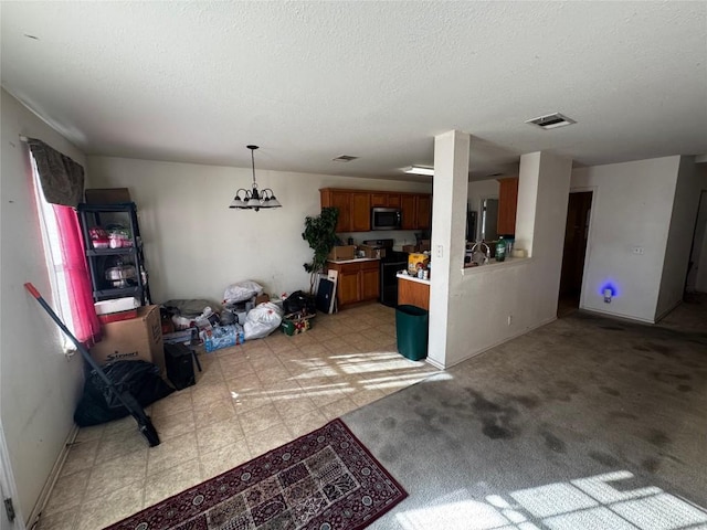 interior space with light carpet, a textured ceiling, decorative light fixtures, a notable chandelier, and black range with electric stovetop