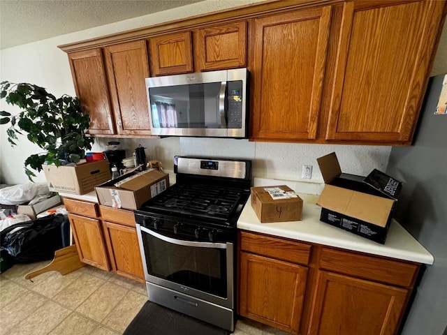 kitchen featuring appliances with stainless steel finishes and a textured ceiling