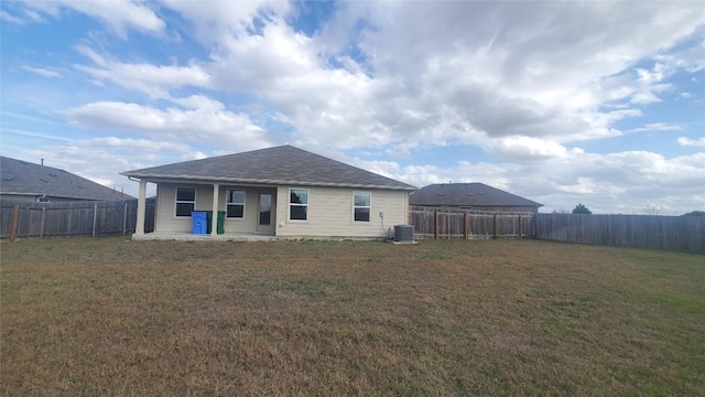 rear view of house featuring a yard, cooling unit, and a patio