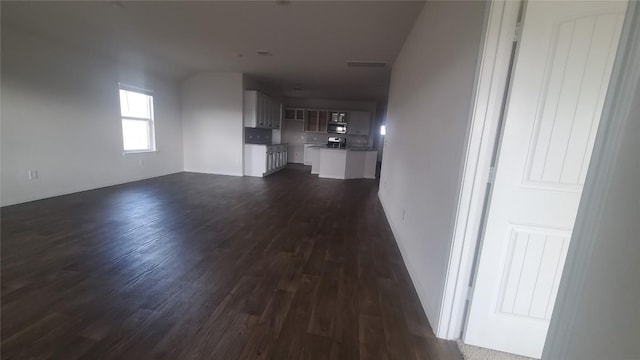 unfurnished living room with dark hardwood / wood-style flooring