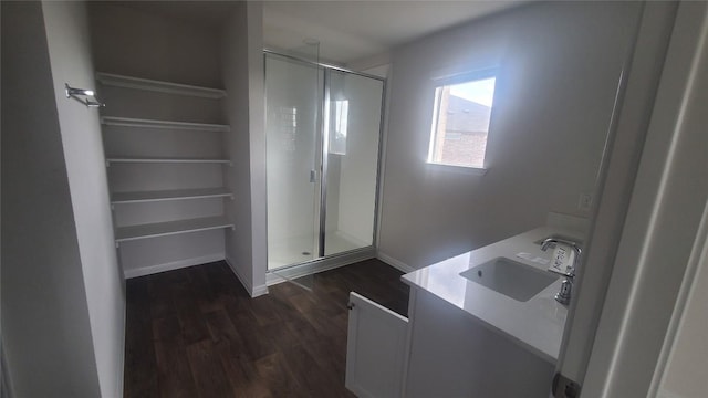 bathroom featuring hardwood / wood-style floors, vanity, and an enclosed shower