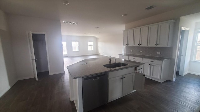 kitchen featuring stainless steel dishwasher, sink, stone countertops, white cabinetry, and an island with sink