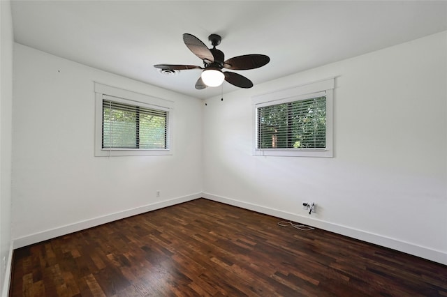 unfurnished room featuring a ceiling fan, baseboards, and dark wood-style flooring