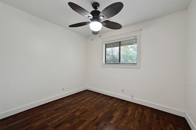 unfurnished room with a ceiling fan, dark wood-type flooring, and baseboards