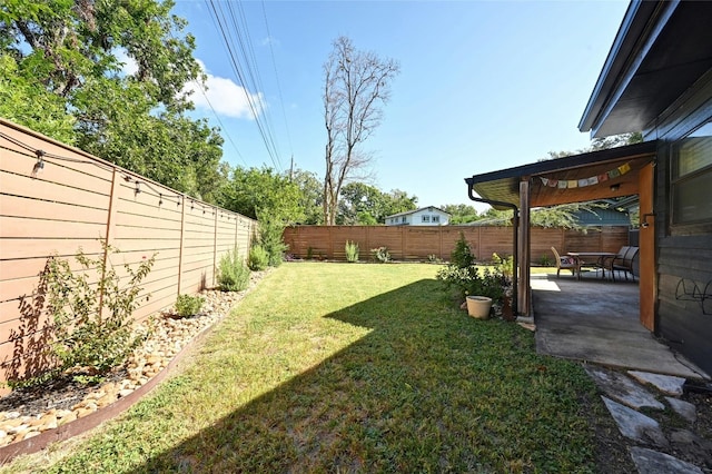 view of yard with a patio area and a fenced backyard