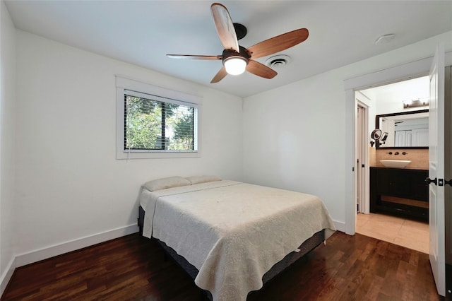 bedroom featuring visible vents, a ceiling fan, wood finished floors, connected bathroom, and baseboards