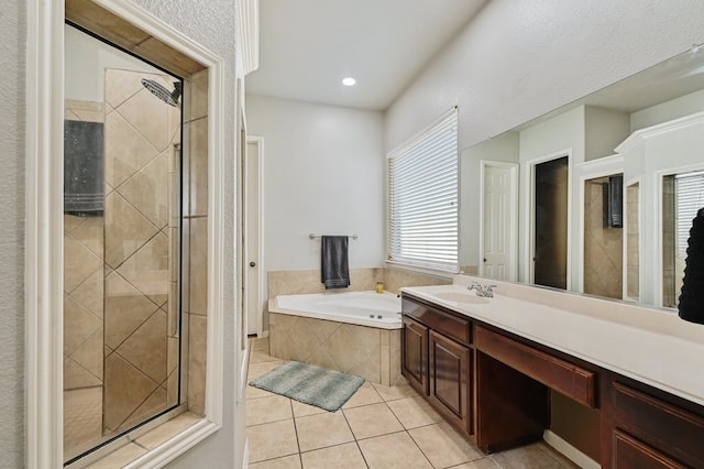 bathroom featuring tile patterned flooring, vanity, and plus walk in shower