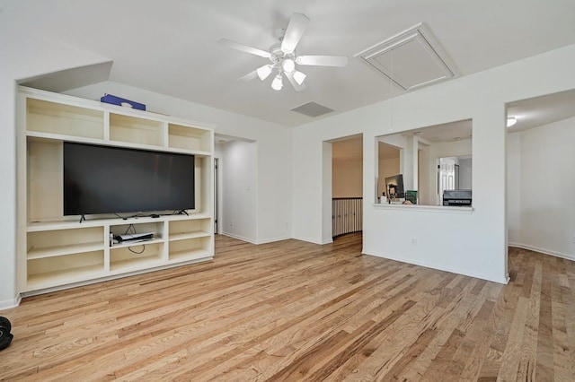 unfurnished living room with built in shelves, ceiling fan, and light hardwood / wood-style floors