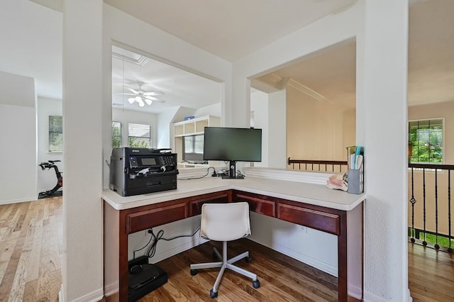 office space with hardwood / wood-style floors, ceiling fan, and built in desk