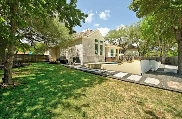 rear view of property featuring a pool and a yard