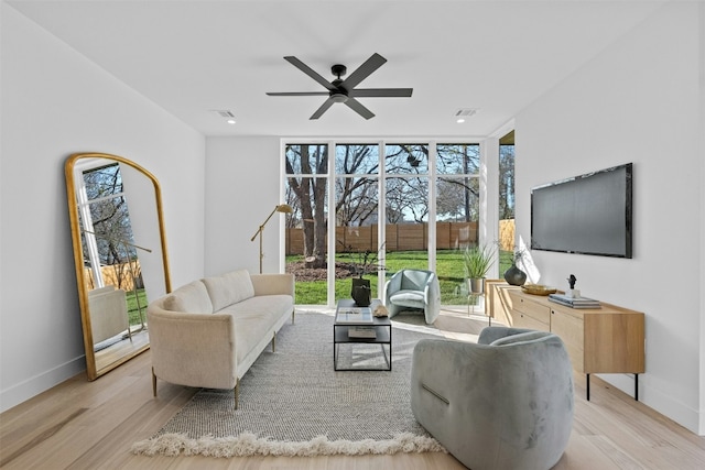 1407 Valleyridge Dr Unit A, Austin, TX 78704 - living room with floor to ceiling windows, baseboards, ceiling fan, and wood finished floors