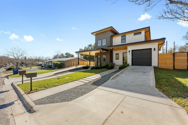 contemporary home featuring a porch, a garage, and a front yard