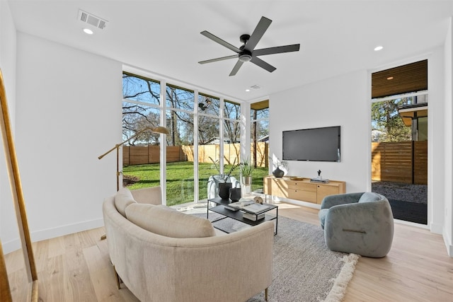 1407 Valleyridge Dr Unit A, Austin, TX 78704 - living area featuring baseboards, floor to ceiling windows, ceiling fan, visible vents, and wood finished floors