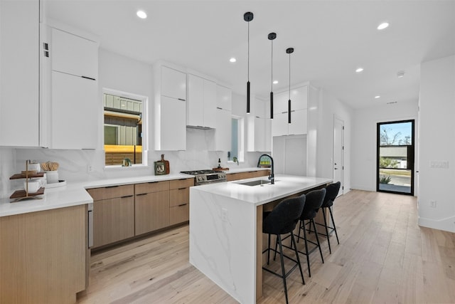 1407 Valleyridge Dr Unit A, Austin, TX 78704 - kitchen with modern cabinets, a sink, backsplash, and a kitchen island with sink