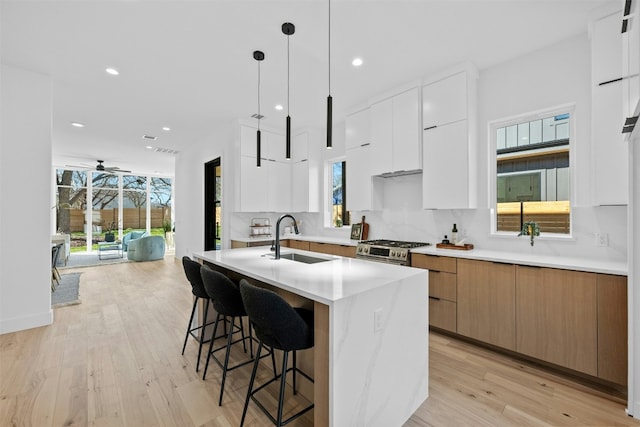 1407 Valleyridge Dr Unit A, Austin, TX 78704 - kitchen with backsplash, a sink, modern cabinets, and gas range