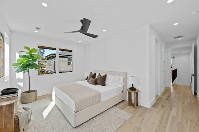 bedroom with light wood-type flooring and ceiling fan