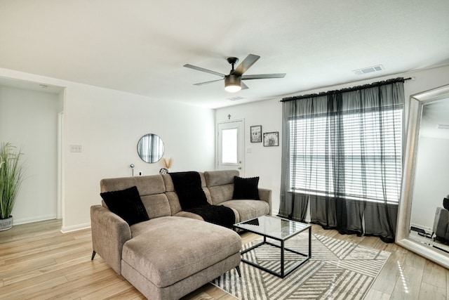 living room featuring ceiling fan and light hardwood / wood-style floors