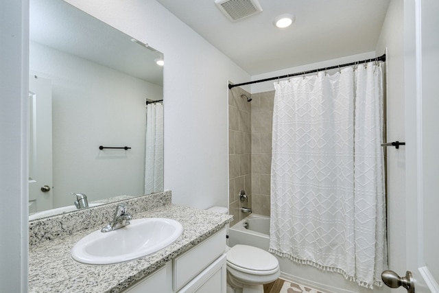 full bathroom with shower / tub combo with curtain, vanity, and toilet