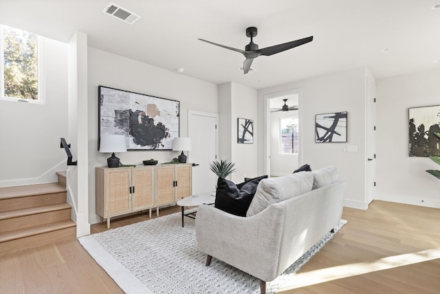 living room featuring ceiling fan and light wood-type flooring