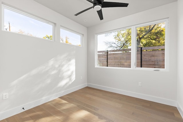 empty room with ceiling fan and light wood-type flooring