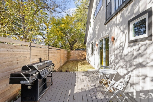 wooden terrace featuring area for grilling