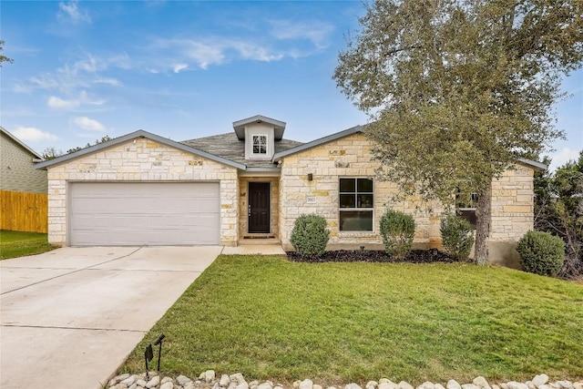 view of front of property with a front yard and a garage