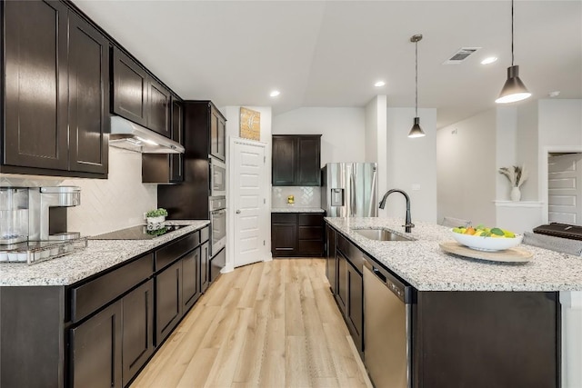 kitchen featuring backsplash, sink, hanging light fixtures, and appliances with stainless steel finishes