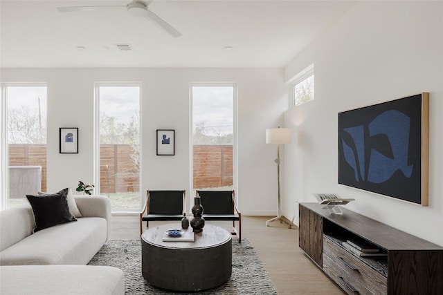 living room featuring ceiling fan and light hardwood / wood-style floors