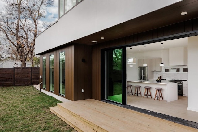 wooden deck featuring exterior bar