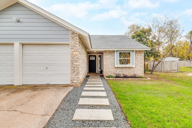 view of front of property featuring a garage and a front yard